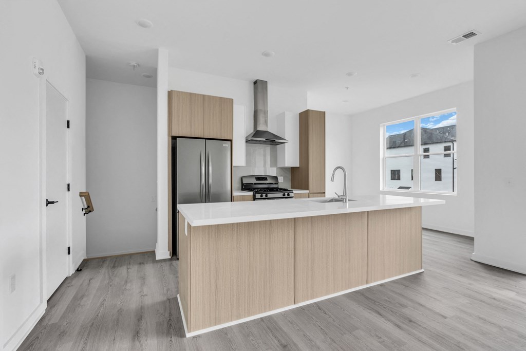 A modern kitchen with a wooden island and stainless steel appliances at The Franklin Marlboro Apartments, Marlboro, New Jersey
