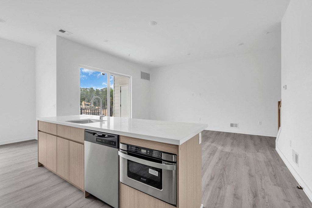 A modern kitchen with a stainless steel dishwasher and oven at The Franklin Marlboro Apartments, New Jersey