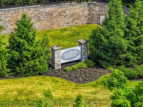 A sign that says All Ridge in front of a wall.