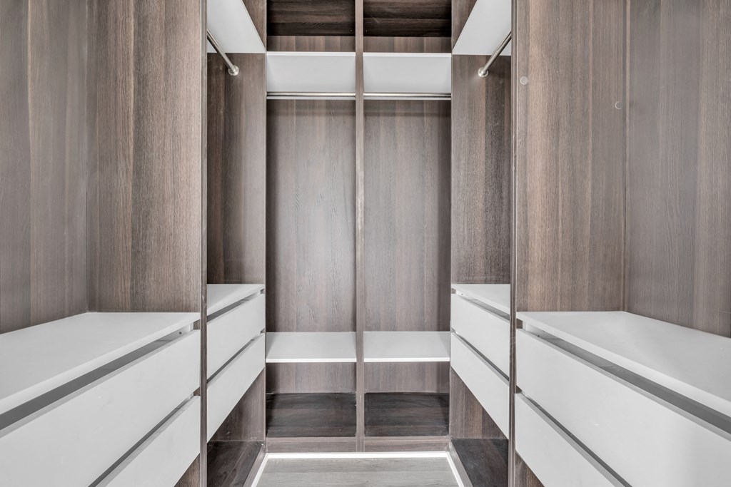 A long hallway with a bench on the side and a door at the end. at The Franklin Marlboro Apartments, New Jersey, 07746