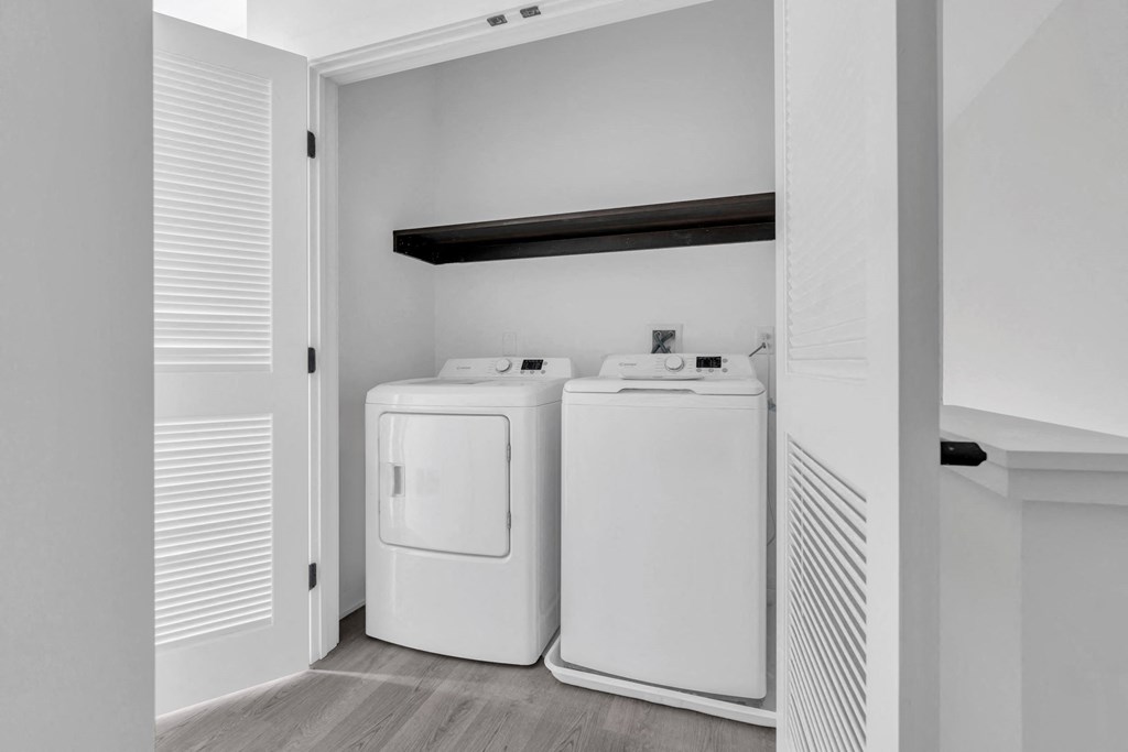 a laundry room with two washers and a dryer in it at The Franklin Marlboro Apartments, Marlboro, New Jersey