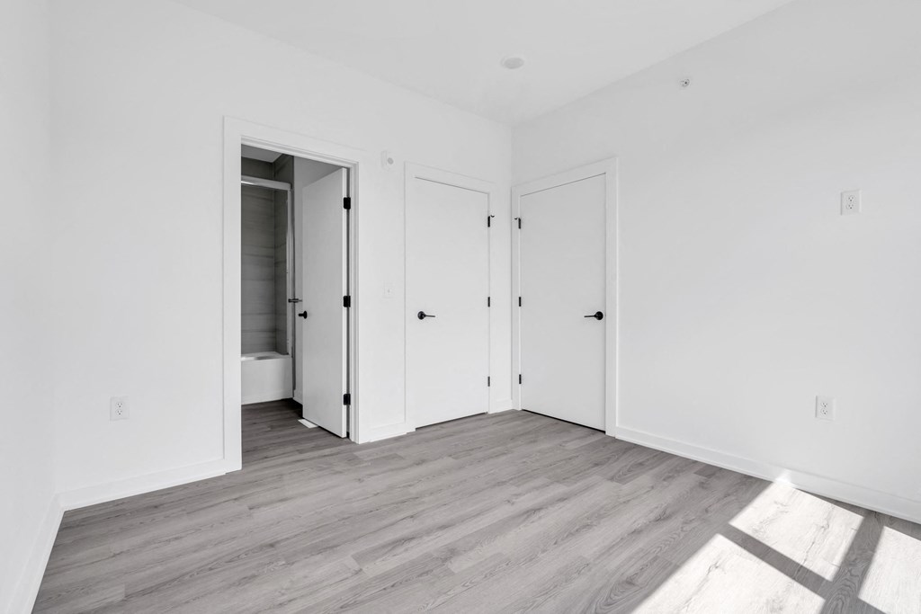 an empty room with white walls and doors at The Franklin Marlboro Apartments, Marlboro, NJ