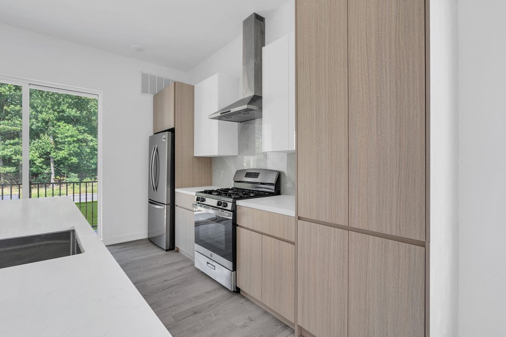 A modern kitchen with wooden cabinets and stainless steel appliances at The Franklin Marlboro Apartments, New Jersey, 07746
