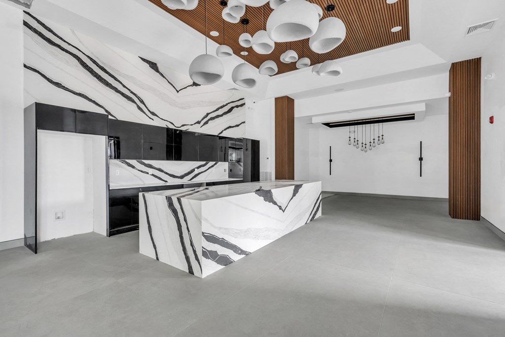 A modern kitchen with a black and white marble countertop. at The Franklin Marlboro Apartments, New Jersey