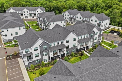 A large, modern apartment complex with multiple buildings and parking lots.