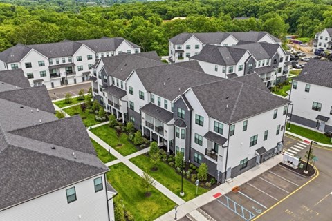 A large white building with a green lawn in front.