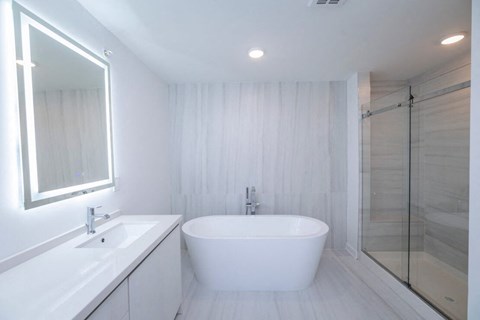 a white bathroom with a tub and a sink at The Franklin at Westfield, Westfield, 07090