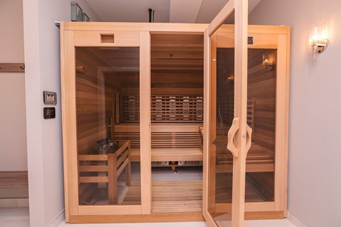 A sauna with wooden benches and a glass door.at The Franklin at Westfield, Westfield, 07090