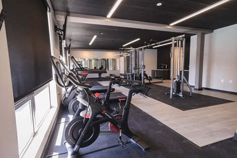 A gym with a row of stationary bikes and a variety of other equipment.at The Franklin at Westfield, Westfield, NJ 07090