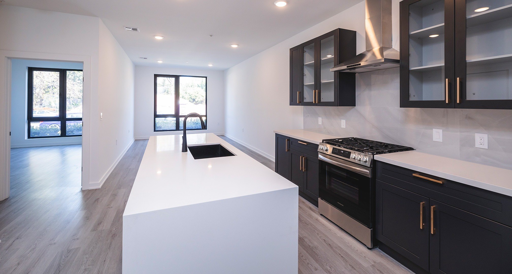 A modern kitchen with dark wood cabinets and a white island.