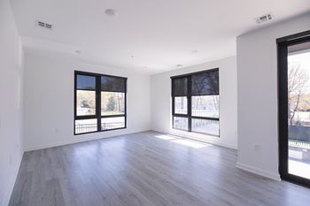 A spacious room with large windows and wooden flooring.at The Franklin at Westfield, Westfield