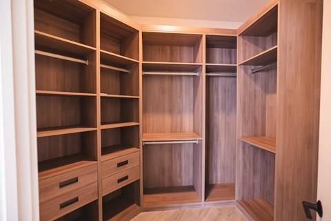 Closet with shelves and drawers in a room.at The Franklin at Westfield, Westfield New Jersey