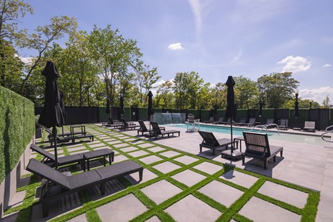 A large outdoor area with a pool and sun loungers.at The Franklin at Westfield, Westfield, NJ 07090