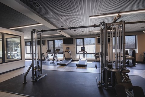 A gym with a variety of equipment including treadmills, weights, and exercise machines.at The Franklin at Westfield, Westfield