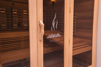 A wooden sauna with a glass door and a handle.at The Franklin at Westfield, Westfield, NJ