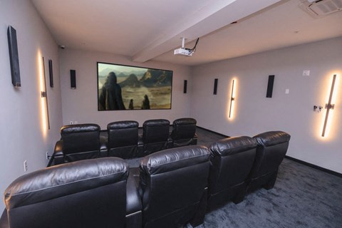 a conference room with leather chairs and a painting on the wall