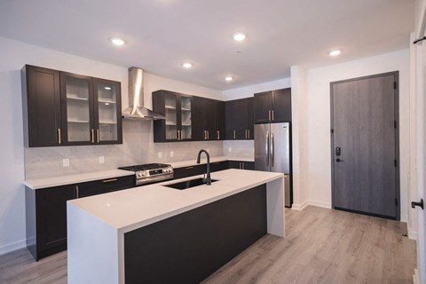a kitchen with a white counter top and black cabinets at The Franklin at Westfield, New Jersey, 07090
