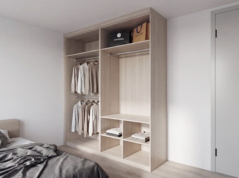 A wooden wardrobe with clothes hanging and shelves with towels and a box labeled