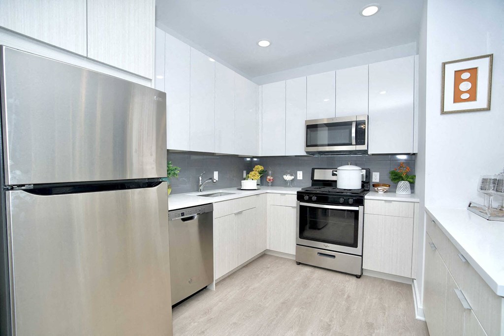 a kitchen with stainless steel appliances and white cabinets