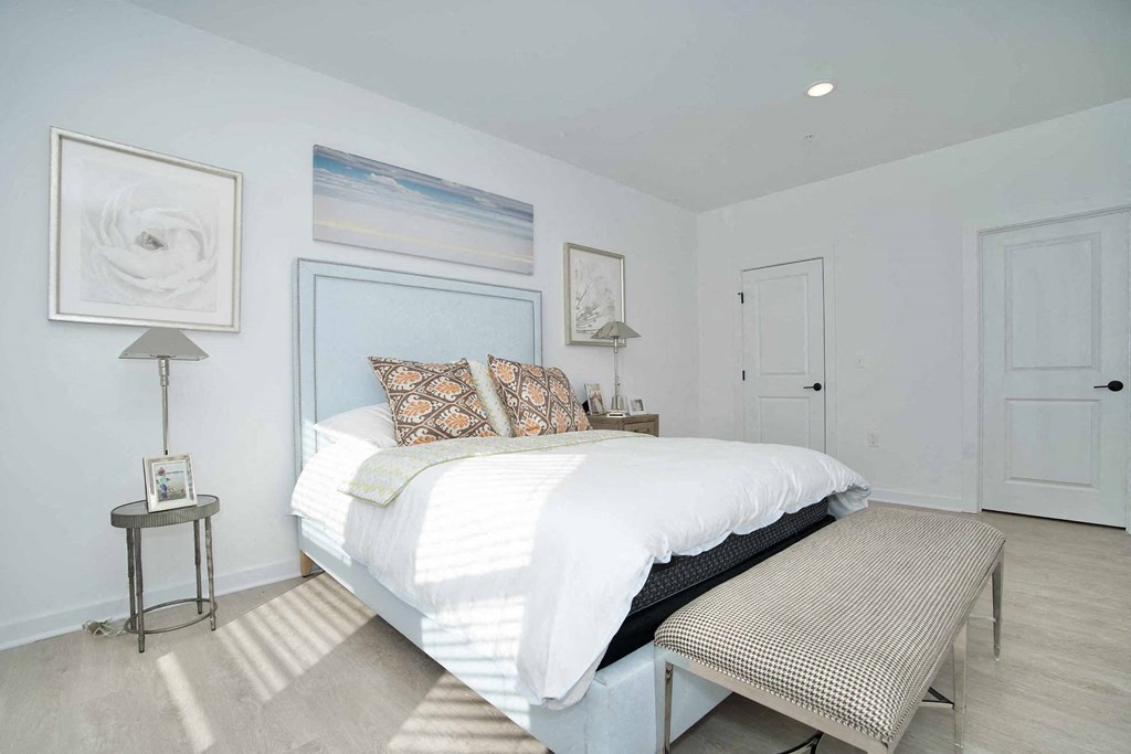 a white bedroom with a bed and white walls