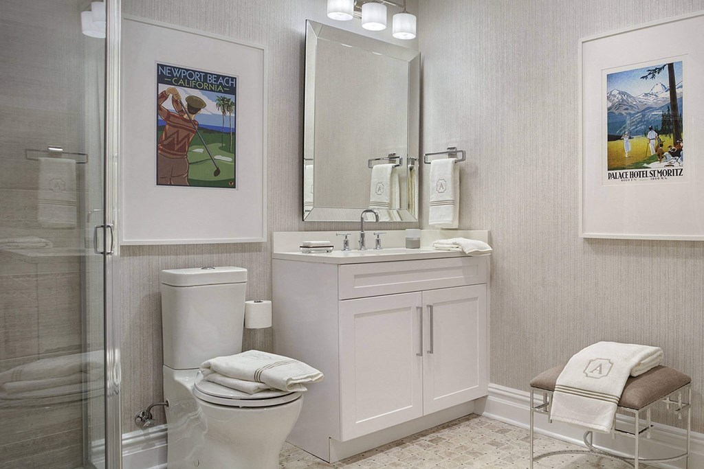 a bathroom with a toilet and a sink and a shower