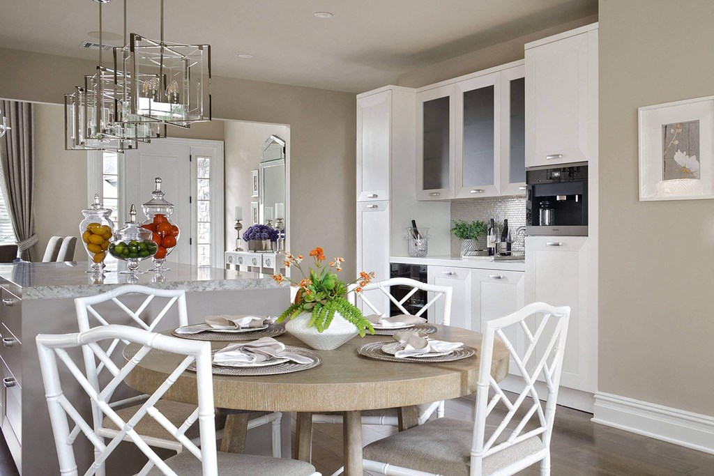 a kitchen and dining room with a table and chairs