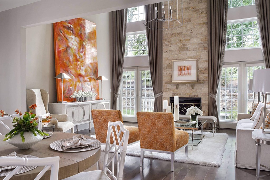 a living room with a table and chairs and a fireplace