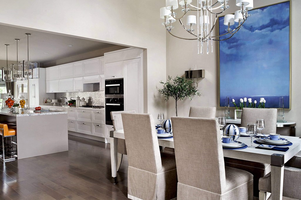 a kitchen and dining room with a table and chairs