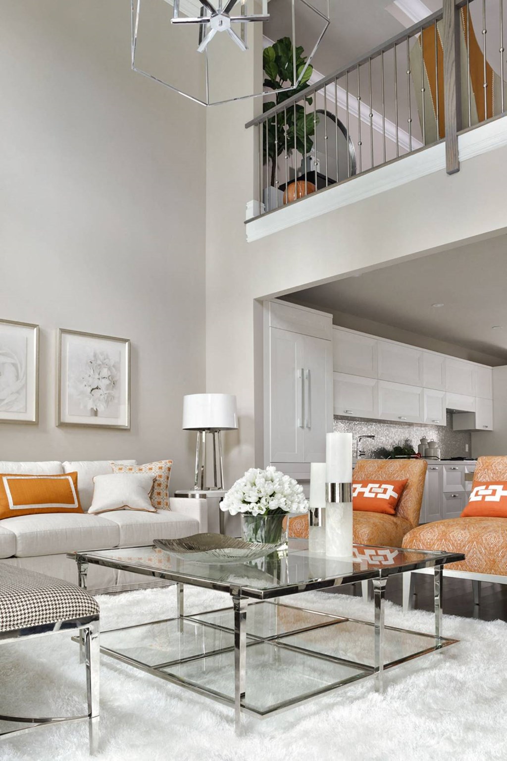 a living room with orange pillows and a glass table