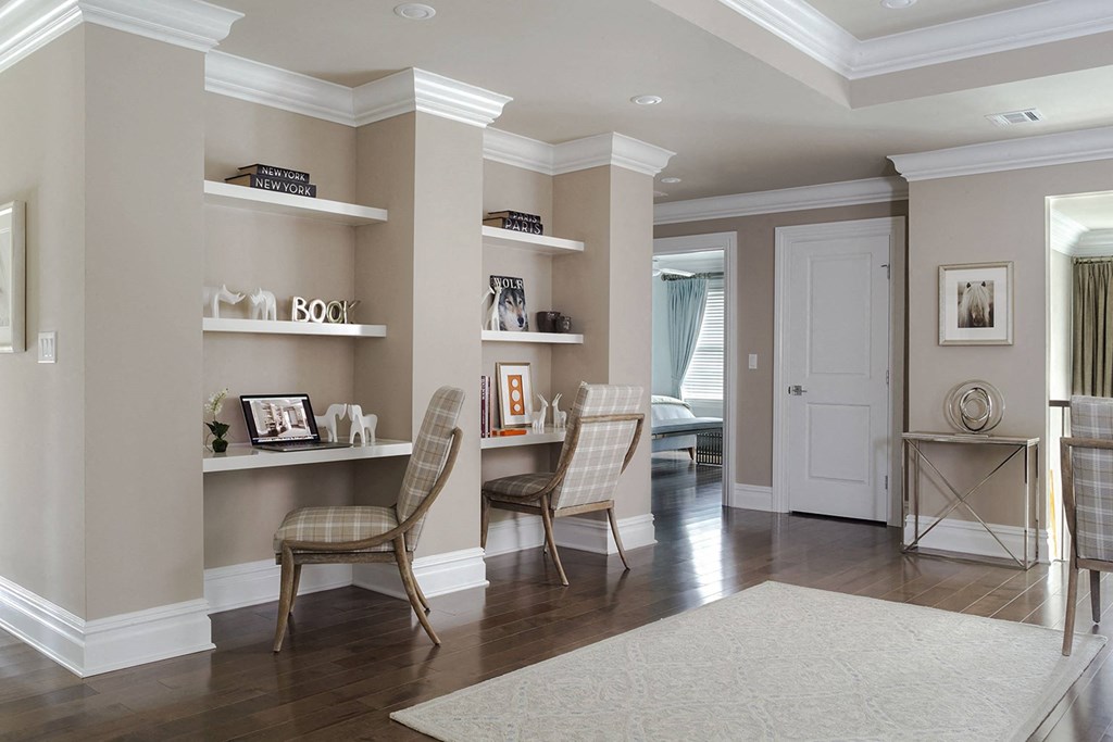 a living room with two chairs and a table and a door