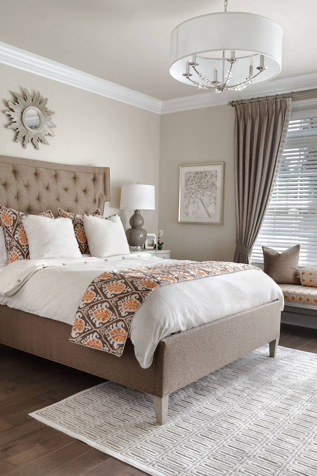 a bedroom with a bed and a chandelier and a window
