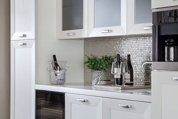 a white kitchen with white cabinets and a sink