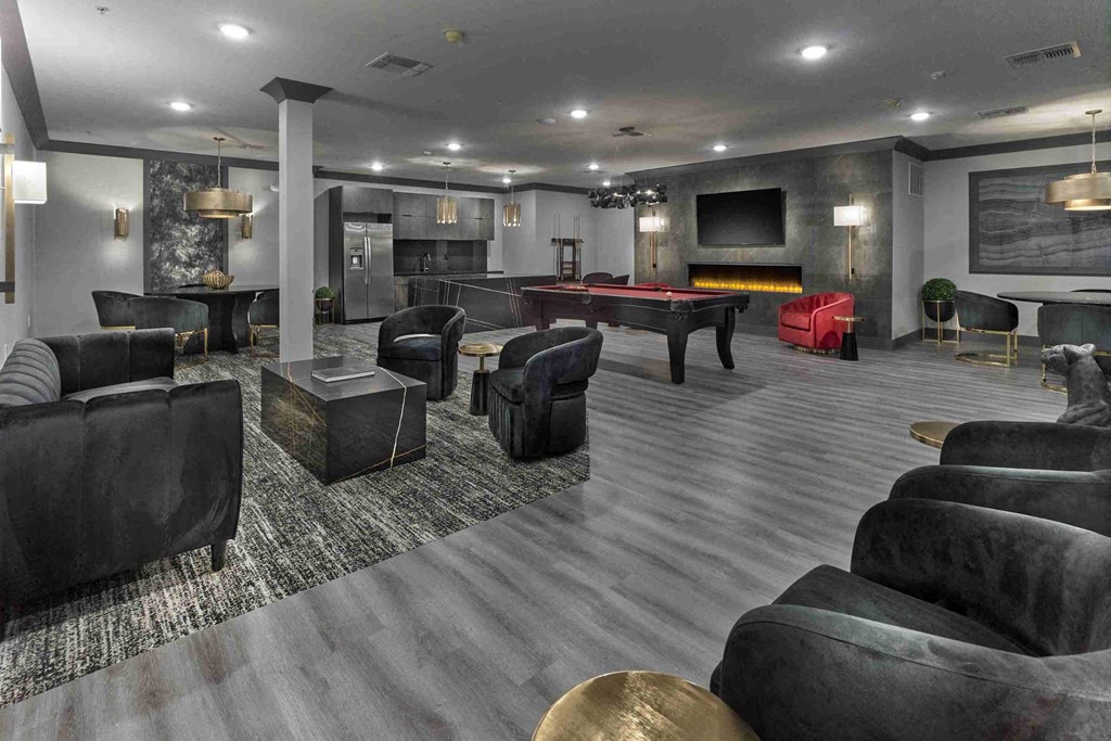 a game room with a pool table and couches
