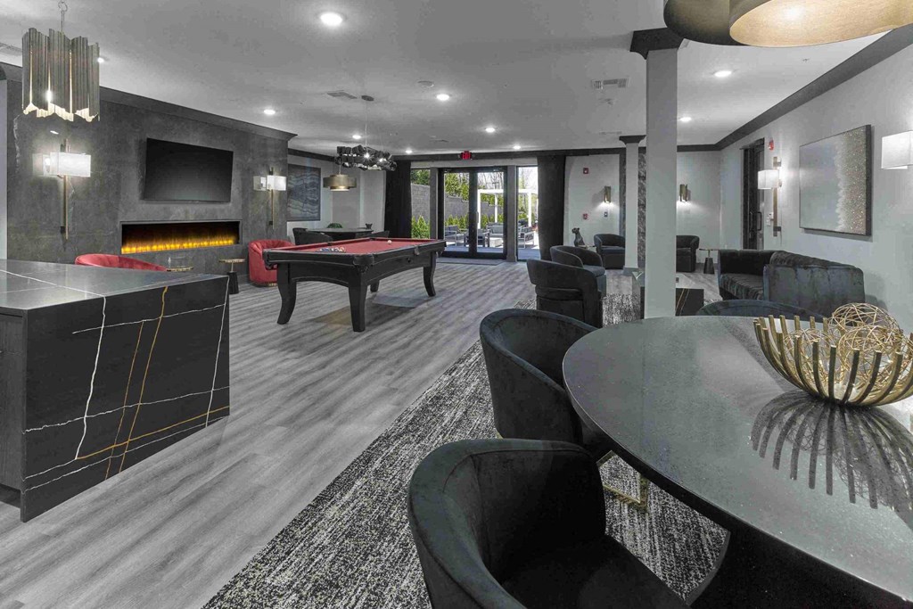 a games room with a pool table and a bar