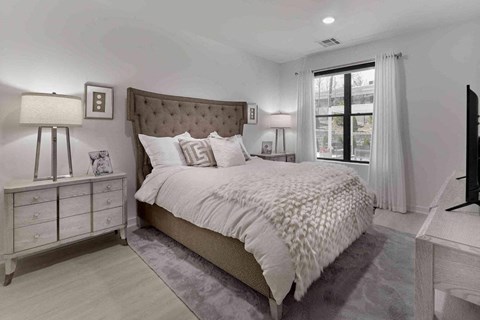 a bedroom with a bed and a window