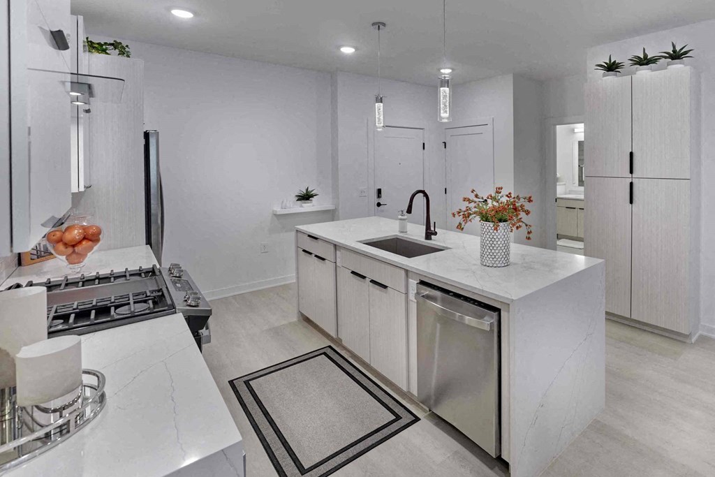 a white kitchen with a sink and a counter top