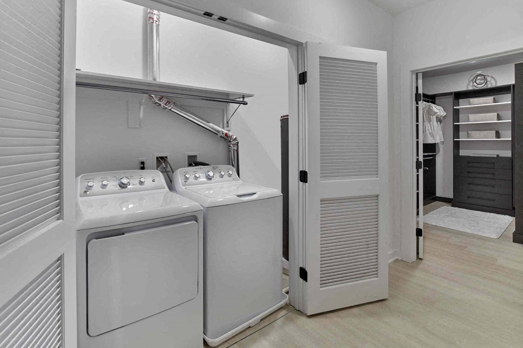 a laundry room with a washer and dryer and a closet