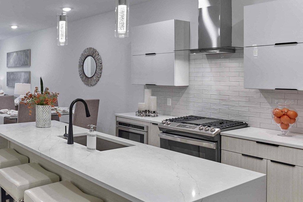 a view of the staircase in a restaurant with white walls and white counter tops