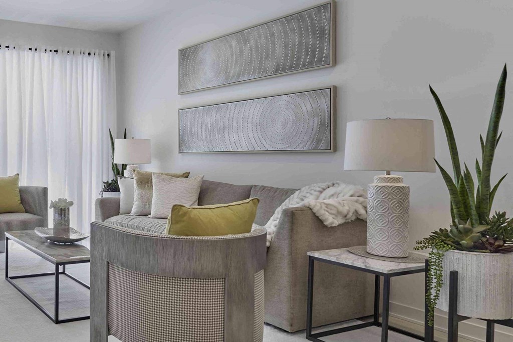 a living room with a couch and two paintings on the wall