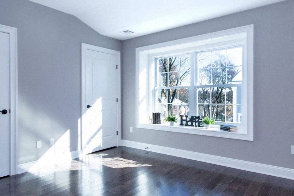 an empty living room with a large window