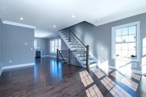 an empty living room with a staircase in a new home