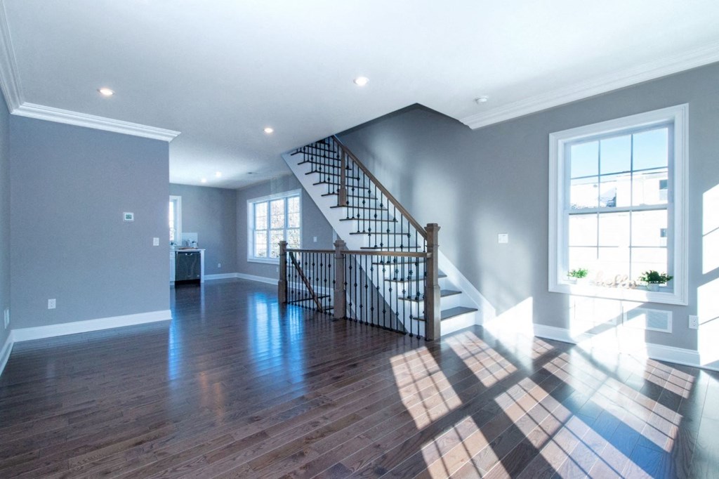 an empty living room with a staircase in a new home
