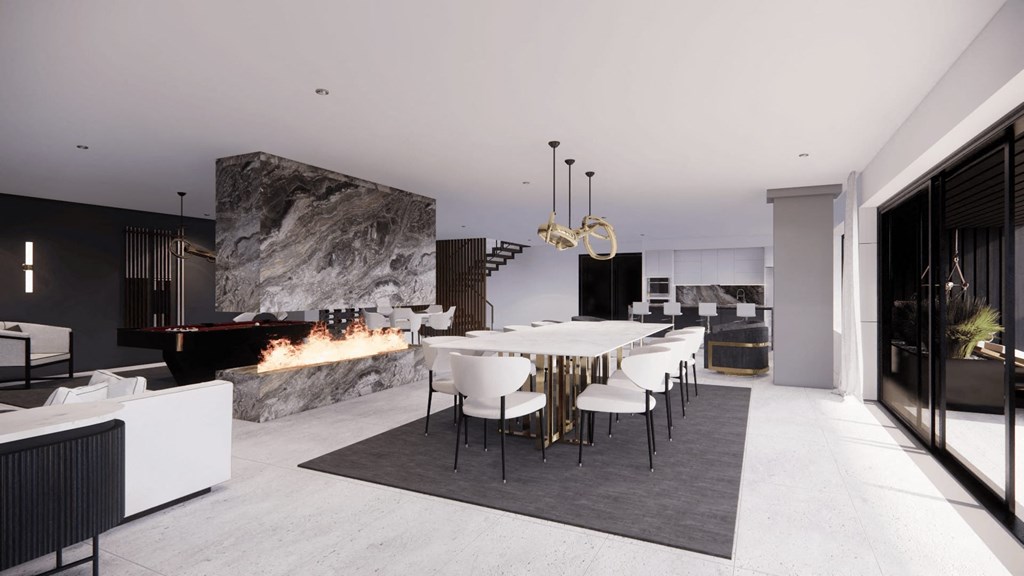 a dining room and living room with a table and chairs and a fireplace