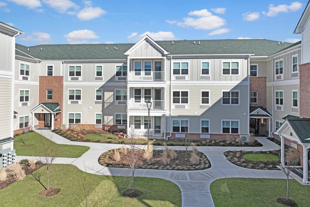 an exterior view of an apartment building with a courtyard