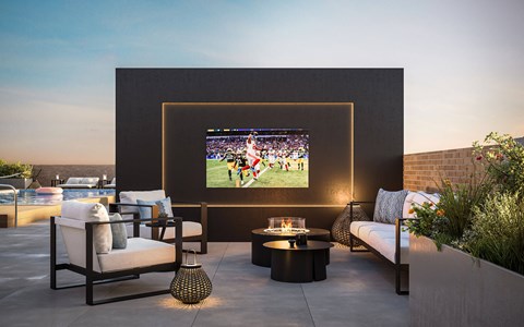 Rooftop terrace with outdoor television and seating at The Franklin at Woodbridge Apartments, Woodbridge