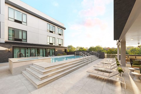 A modern house with a pool and lounge chairs.