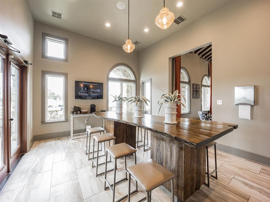 a large kitchen with a bar and stools at Palisades at Pleasant Crossing, Rogers, 72758