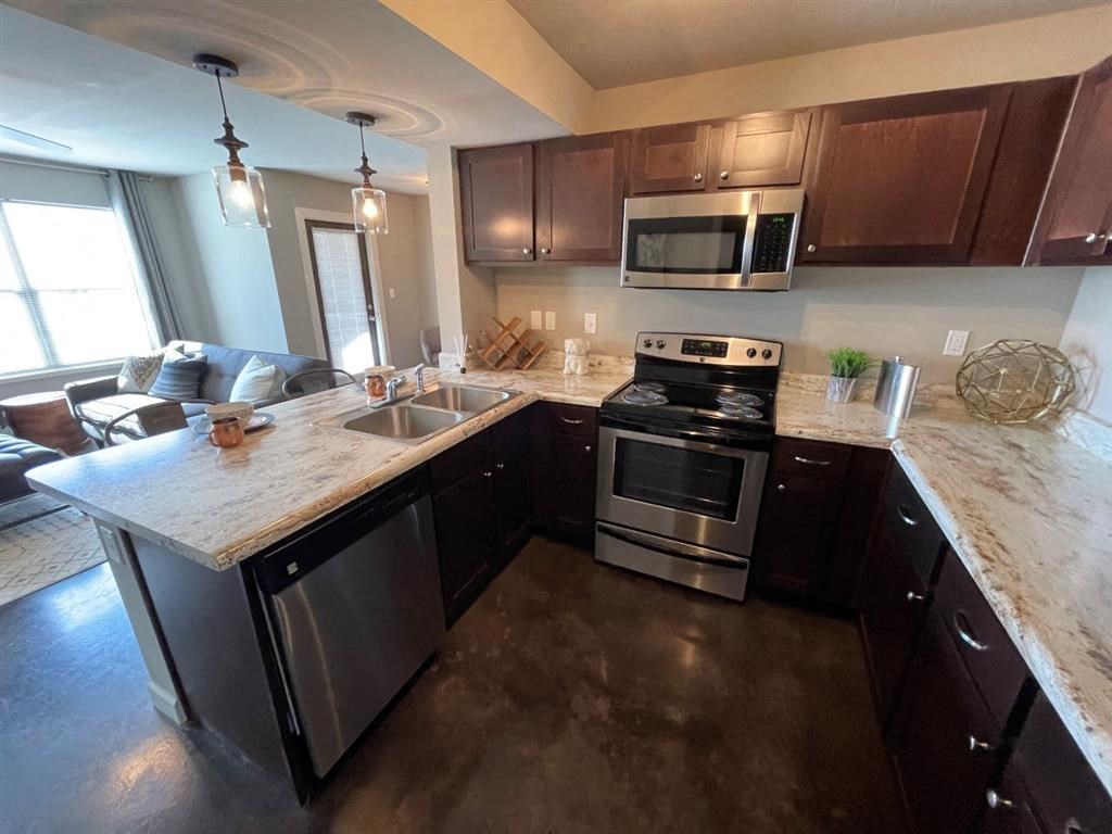 a kitchen with stainless steel appliances and a marble counter topat Palisades at Pleasant Crossing, Arkansas