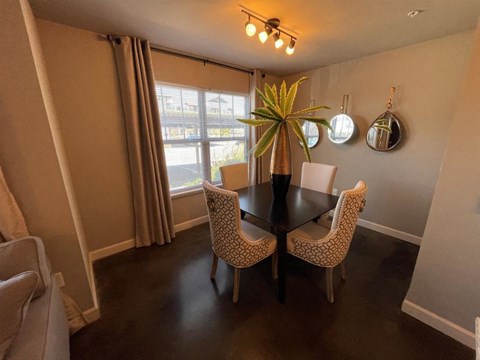 a dining room with a table and chairs