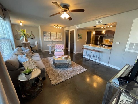 A living room with a grey couch and a white coffee table.